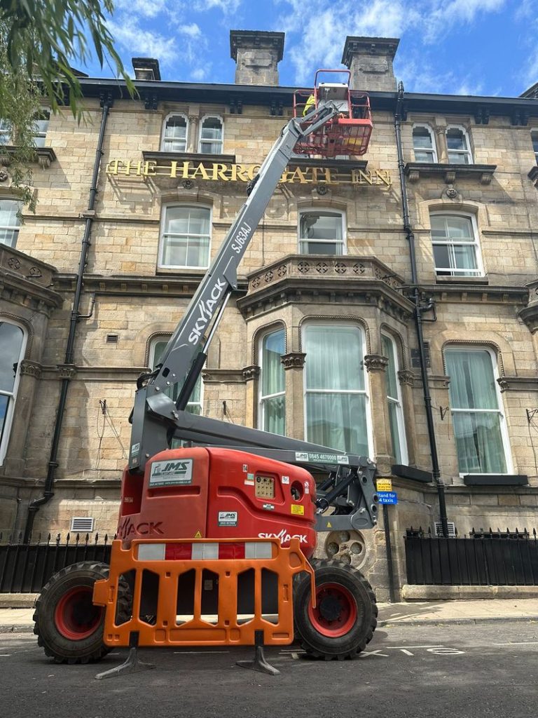 Trojan FM cleaning the windows of the Harrogate Inn.