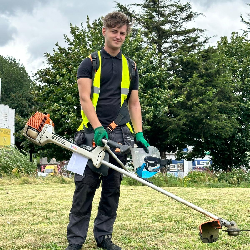 Trojan FM staff member on a landscaping job