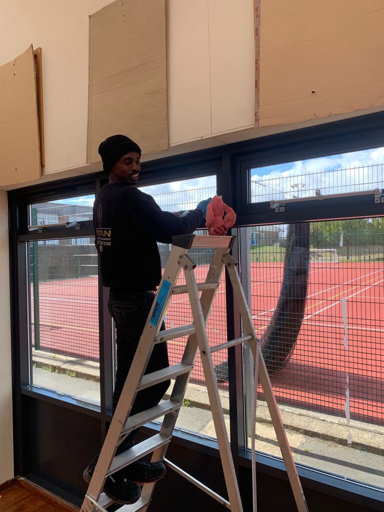 Trojan FM Staff Member during a after build clean.